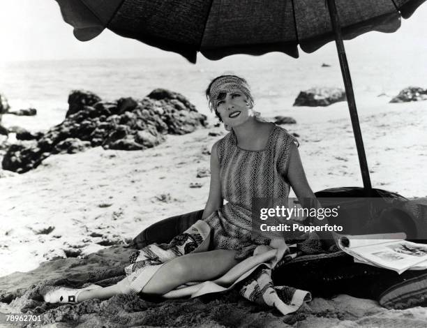 Cinema Personalities, pic: circa 1930, American actress Jean Arthur is pictured relaxing on the beach