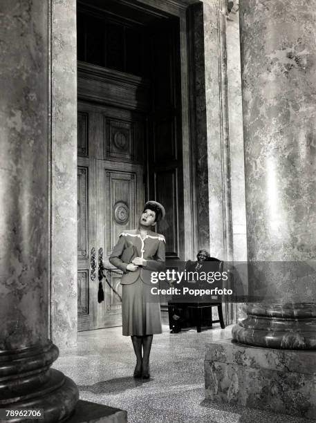 Cinema Personalities, pic: circa 1942, American actress Jean Arthur is pictured in a scene from the film "The Talk of the Town" with Clarence Muse,...