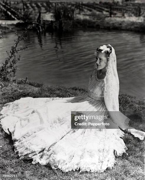 Cinema Personalities, pic: circa 1930's, American actress Jean Arthur is pictured wearing a flowing dress and veil