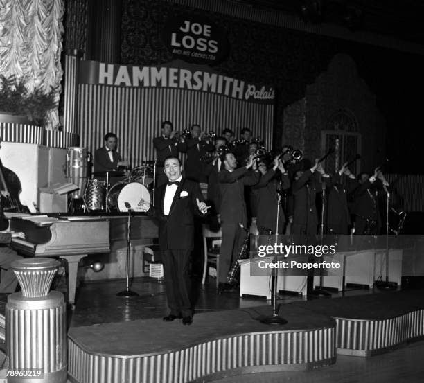 London, England Bandleader Joe Loss is pictured performing with his orchestra at the Hammersmith Palais