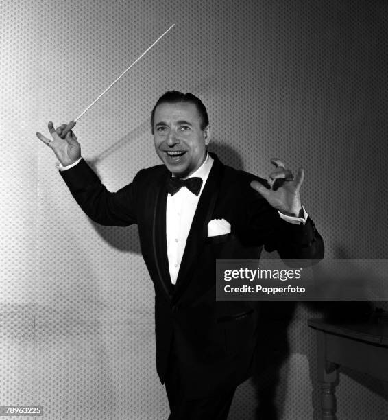 London, England Bandleader Joe Loss is pictured conducting at the Hammersmith Palais