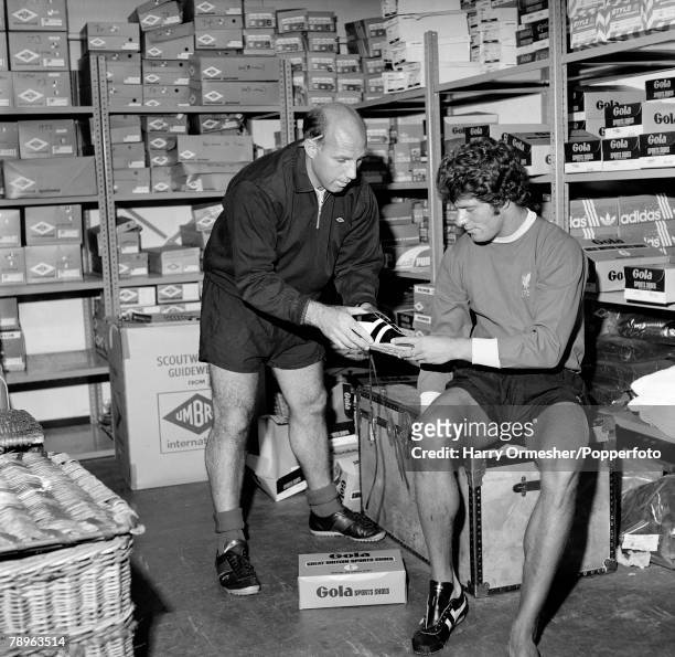 Liverpool trainer Ronnie Moran helps find new football boots for footballer Phil Boersma on the first day of training for the new season on July 10,...