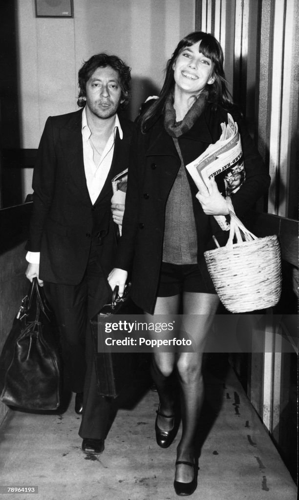 Music Personalities. pic: 1st February 1971. French singer/songwriter/director Serge Gainsbourg pictured with his girlfriend, the English actress Jane Birkin, at London's Heathrow Airport.