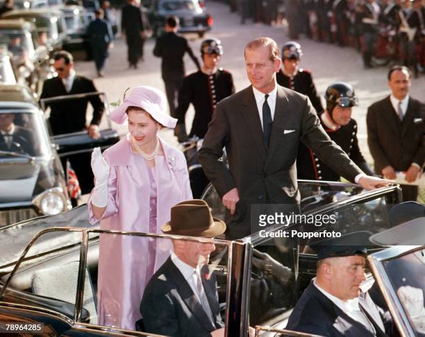 Queen Elizabeth II and Prince Philip, the Duke of Edinburgh, touring the streets of Rome in an open-topped car during their 1961, Royal Tour to Italy.