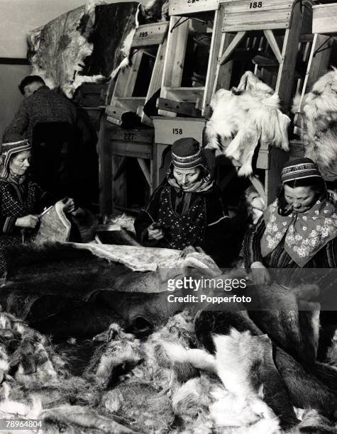 War and Conflict, World War II, pic: 8th January 1940, Pipe smoking Saami women make reindeer fur coats for Finnish troops in Northern Finland during...