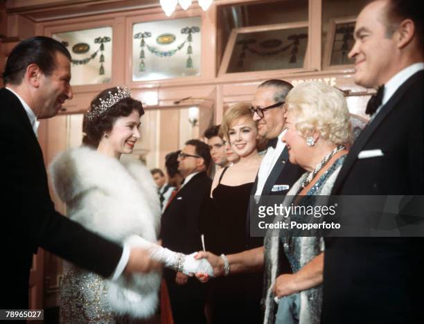 London, England Queen Elizabeth II is presented to the various performers at the Royal Variety Performance, Pictured waiting in line is American...