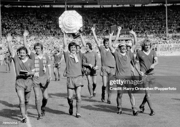 Liverpool players celebrate with the trophy after the FA Charity Shield between Arsenal and Liverpool at Wembley Stadium on August 11, 1979 in...