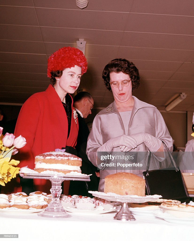 England. 1962. Queen Elizabeth II (left) is pictured judging a cake competition during a visit to Slough.