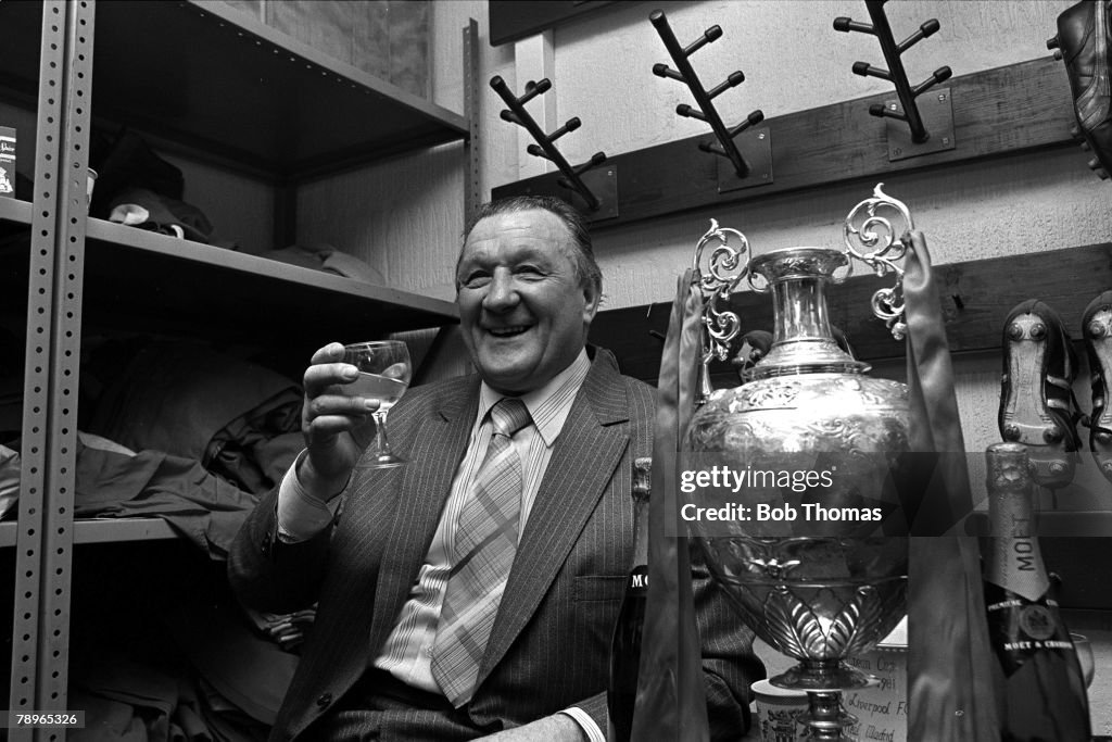 15th May 1982. Anfield, Liverpool. Liverpool FC Manager Bob Paisley toasts his sides Division One Championship success in the boot-room with the trophy.