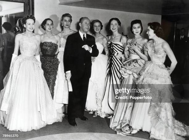 Fashion French designer Chritian Dior with models wearing some of his designs
