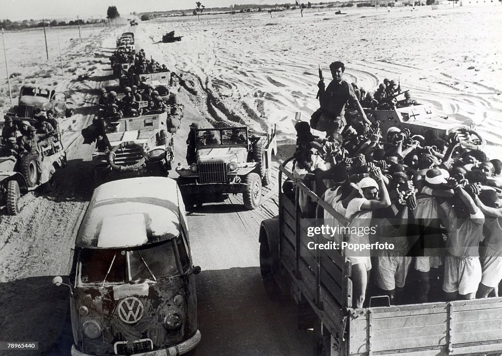 War and Conflict. The 1967 Six Day War. Middle East. Egyptian POW's pass Israeli troop carriers during the battle.