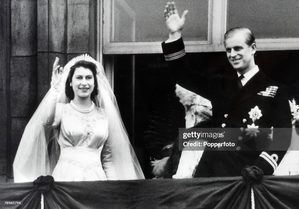 British Royalty. London, England. 20th November 1947. Princess Elizabeth (now The Queen) and Prince Philip, The Duke of Edinburgh wave to crowds from the balcony of Buckingham Palace following their marriage.