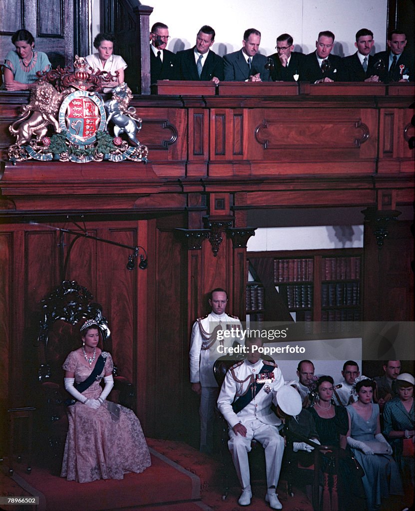 1954. Royal Tour of Australia. Queen Elizabeth II and Prince Philip, the Duke of Edinburgh, are pictured at the opening of the New South Wales Parliament in Sydney. The Queen is seated on the Throne on the Legislative Council. Behind the Duke (standing) i