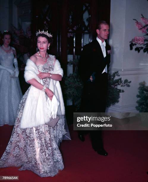 Royal Tour of New Zealand, Queen Elizabeth II and Prince Philip, the Duke of Edinburgh, are pictured arriving at Wellington Town Hall for Investiture