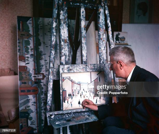 Manchester, England British artist LS Lowry is pictured at work in his Salford home