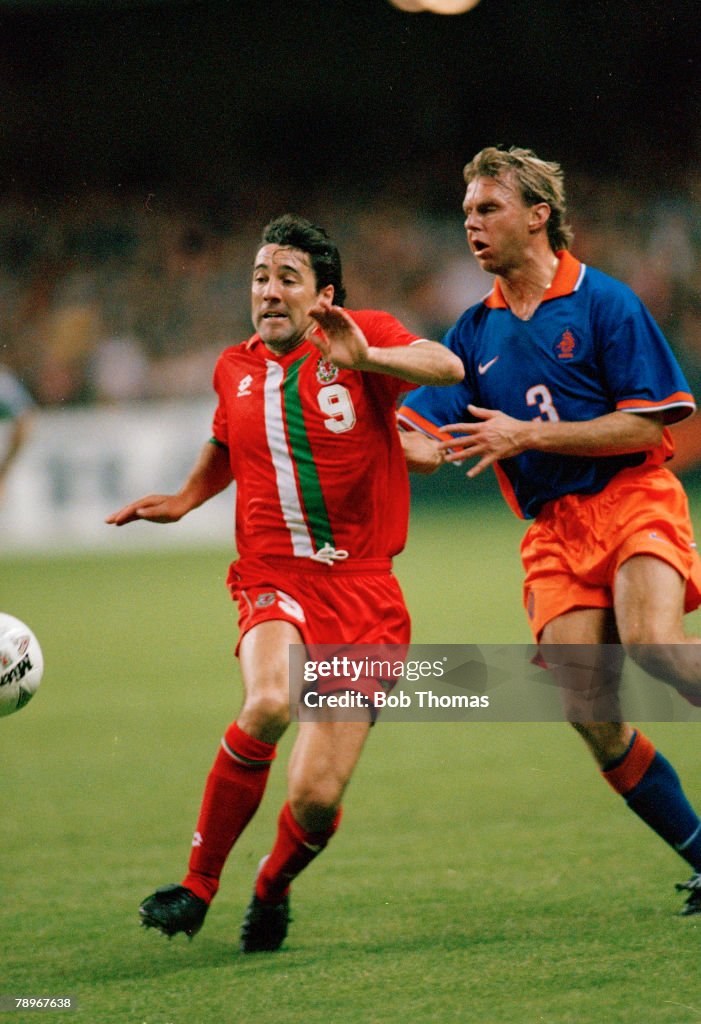 Sport. Football. pic: 5th October 1996. World Cup Qualifier in Cardiff. Wales 1 v Holland 3. Wales striker Dean Saunders challenged by Holland's S. Valckx. Dean Saunders won 75 Wales international caps between 1986-20001.