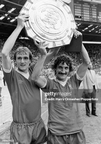 Phil Thompson and Terry McDermott of Liverpool celebrate with the trophy after the FA Charity Shield between Liverpool and West Ham United at Wembley...