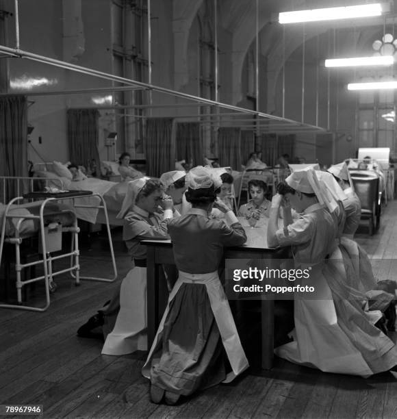 Leeds, England A group of nurses kneel to pray before the start of a day's work in the women's medical ward
