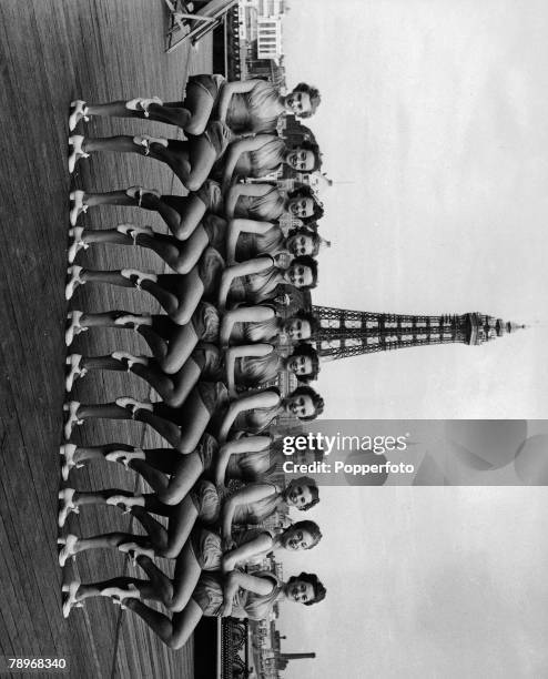 Volume 1, Page 43, Picture 9 The Tiller girls at Blackpool performing a dance routine, with the famous tower in the background