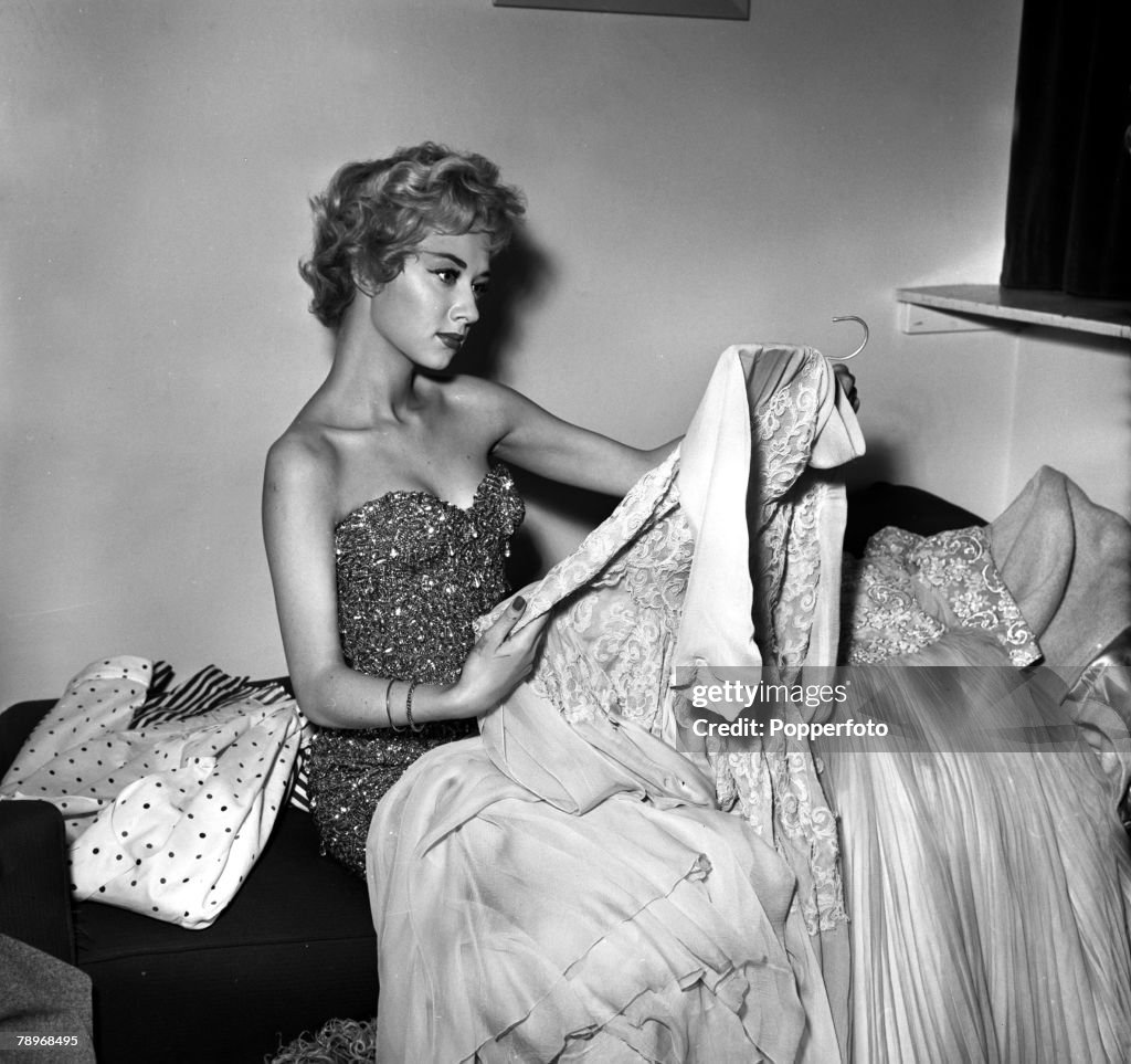 London, England. 1957. Actress Carole Lesley is pictured with some of her clothes at home.