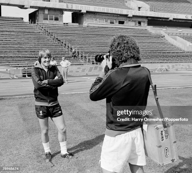 Kenny Dalglish of Liverpool has his picture taken by teammate Terry McDermott during a break in training prior to the European Cup 1st Round 2nd Leg...