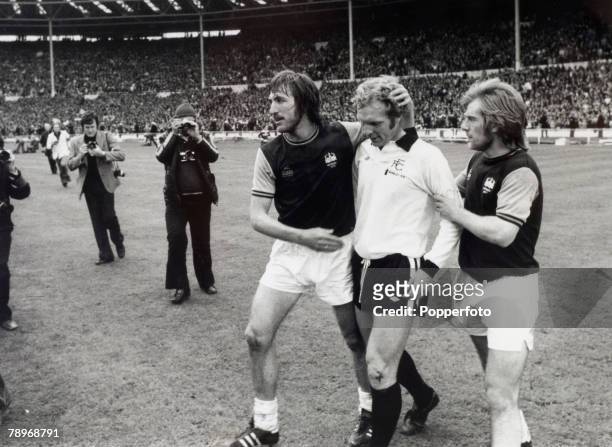 3rd May 1975, 1975 FA, Cup Final at Wembley, West Ham United 2 v Fulham 0, West Ham United captain Billy Bonds, left and Graham Paddon console Fulham...