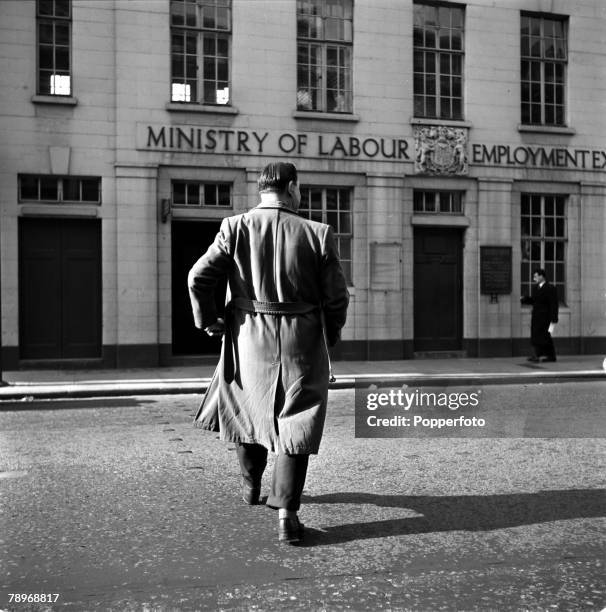 England Unemployment, A man is pictured waiting for the Ministry of Labour and National Service to open