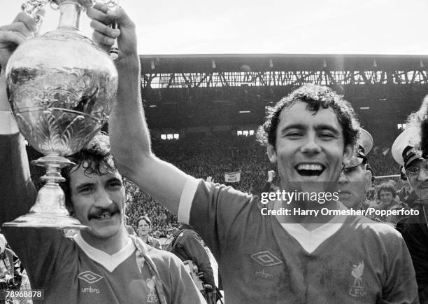 Terry McDermott and Ray Kennedy of Liverpool celebrate with the League Championship trophy after the Football League Division One match between...