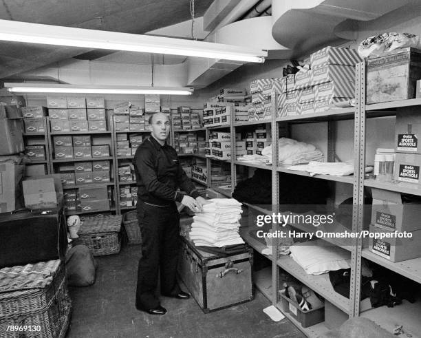 Liverpool FC trainer Ronnie Moran packing away towels in the kit room at Anfield in Liverpool, England, circa March 1976.