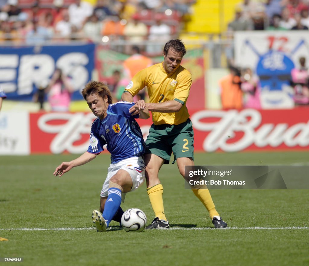 BT Sport. Football. FIFA World Cup. Kaiserslautern. 12th June 2006. Australia 3 v Japan 1. Japan's Yuichi Komano battles for the ball with Australia's Lucas Neill, right.