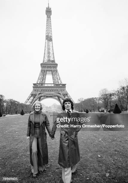 Liverpool FC and England footballer Kevin Keegan and his wife Jean in front of the Eiffel Tower in Paris, France, circa November 1976.