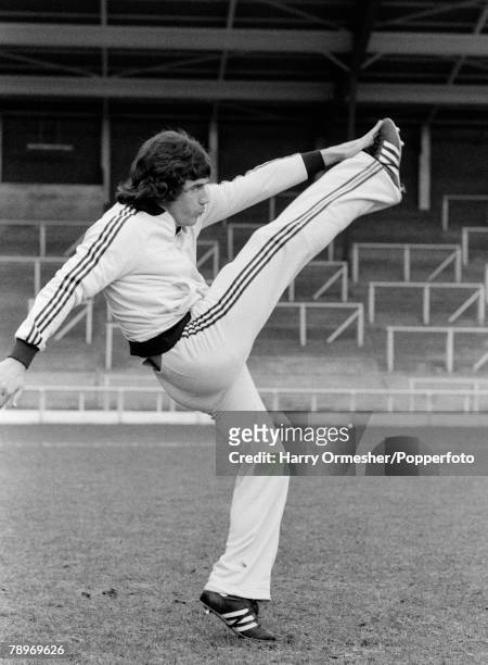 Liverpool FC footballer Kevin Keegan practices high kicking in his 'flared' Adidas tracksuit as part of a training routine at Anfield in Liverpool,...