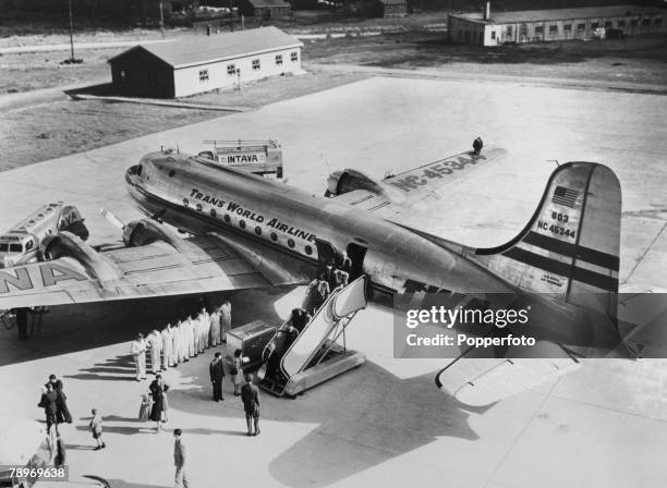 Transport, Aviation, Newfoundland, Canada, Circa 1950's, A Douglas DC4 owned by TWA Airlines unloading passengers at Gander airport
