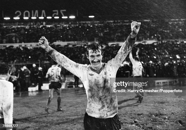 In torrential rain, Terry McDermott of Liverpool celebrates after the European Cup Quarter Final 1st Leg between SL Benfica and Liverpool at the...