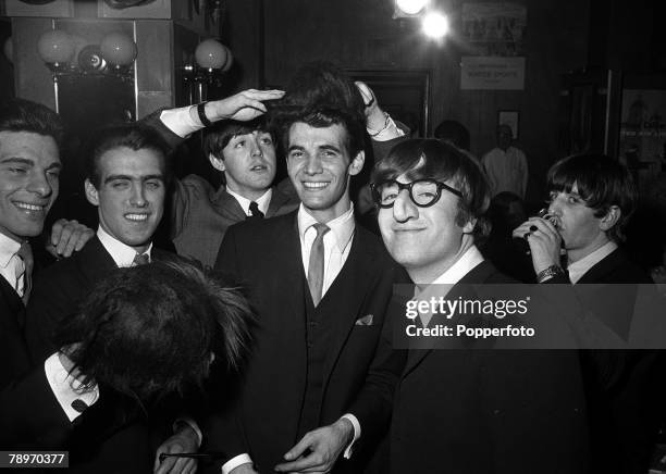 The Beatles 1964 US Tour, John Lennon pictured wearing a comical false nose and glasses as The Beatles attend a party at the Peppermint Lounge during...