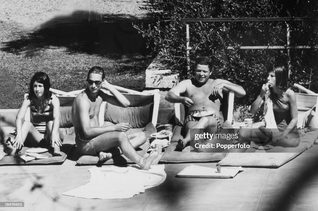 British Royalty. pic: 1964. California, USA. Prince William of Gloucester, 2nd left, pictured relaxing in the sun during his time at Stanford University. Prince William, 1941-1972, (grandson of King George V) was killed in a plane crash in 1972.