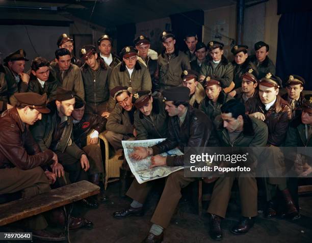 Lieutenant Colonel James Averell Clark briefs USAAF North American P-51 Mustang pilots from 334th Fighter Squadron prior to a fighter sweep from RAF...