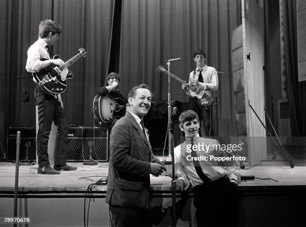 English pop group The Beatles on stage with presenter Brian Matthew during a recording session for the BBC Radio show 'Saturday Club' at the...