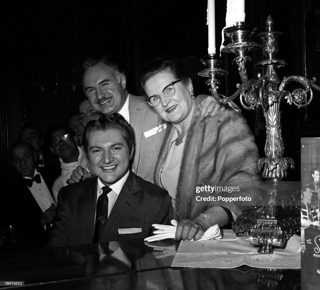 England. 1956. Musician and pianist Liberace is pictured with his mother and brother George at a press reception.