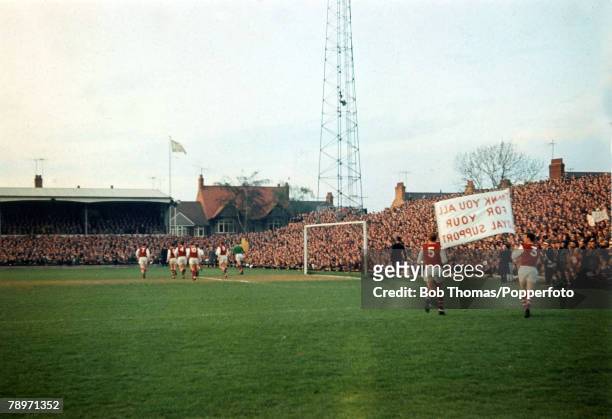 Season 1964-1965, Northampton Town players parade a banner in front of the Spion Kop at the County Ground thanking the fans for their loyal support...