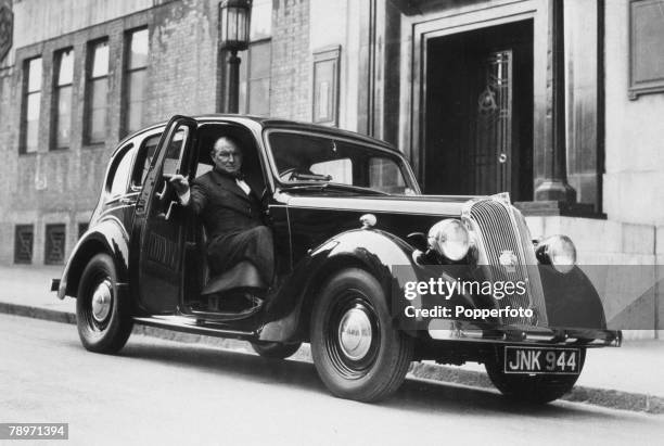 Circa 1955, Arsenal Manager Tom Whittaker in his car outside Highbury Stadium