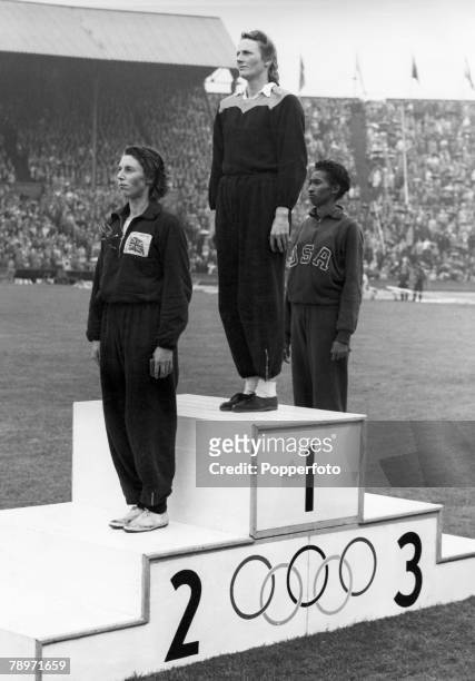 Olympic Games, London, England, Women's 200 Metres Final, Holland's Fanny Blankers-Koen stands on the podium after winning the gold medal along with...