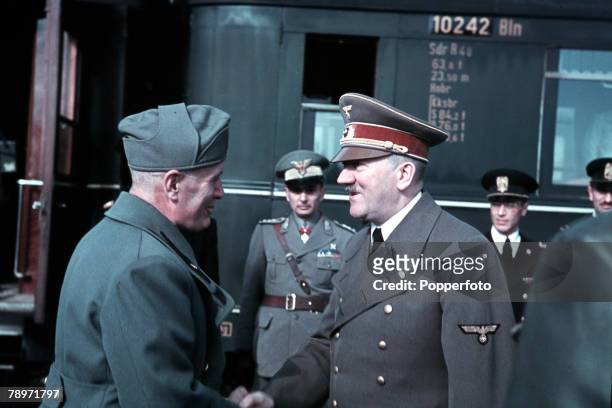 German Chancellor Adolf Hitler meets with Italian Prime Minister Benito Mussolini and Axis officers at a railway station in Florence, Italy during...