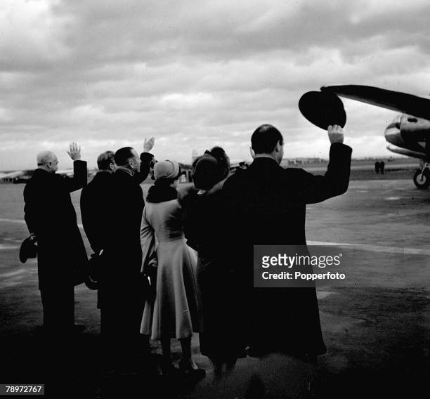 King George VI and Queen Elizabeth wave to Princess Elizabeth and her husband Prince Philip as they see them off at London airport for their tour of...