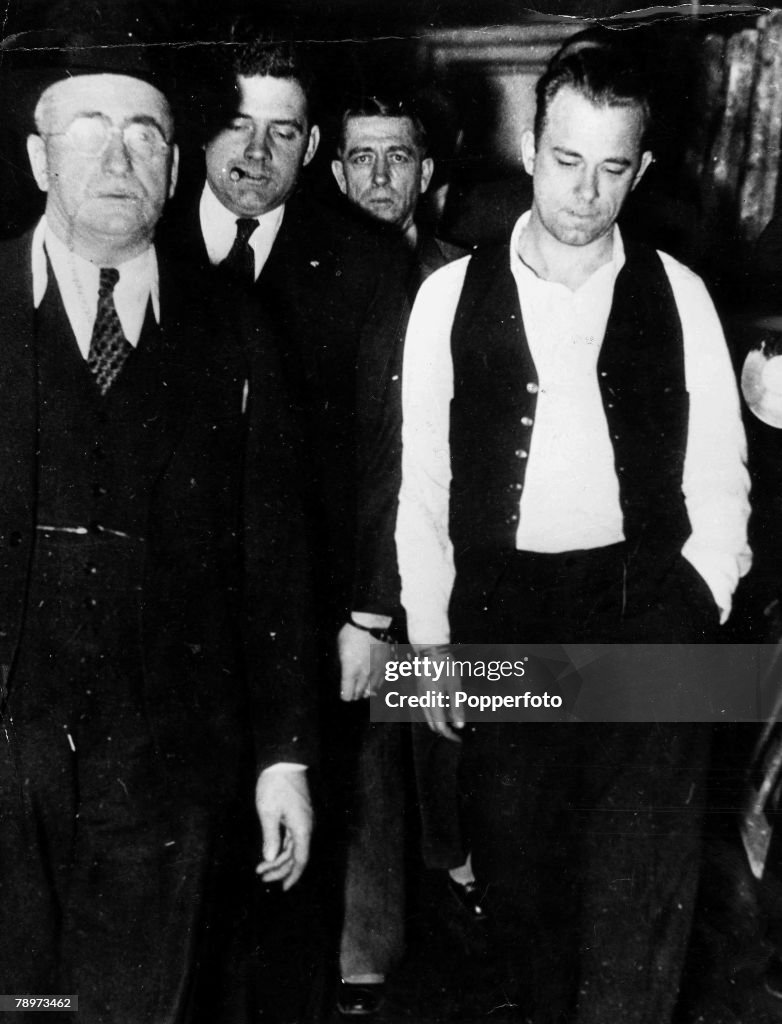 2nd January 1934. John Dillinger is pictured being taken to the -Showup+ in the county jail in Crown point, Indiana, where he was viewed and identified by 22 witnesses as the machine gunner who killed policemen Patrick O+Malley in the $20,000 robbery of t