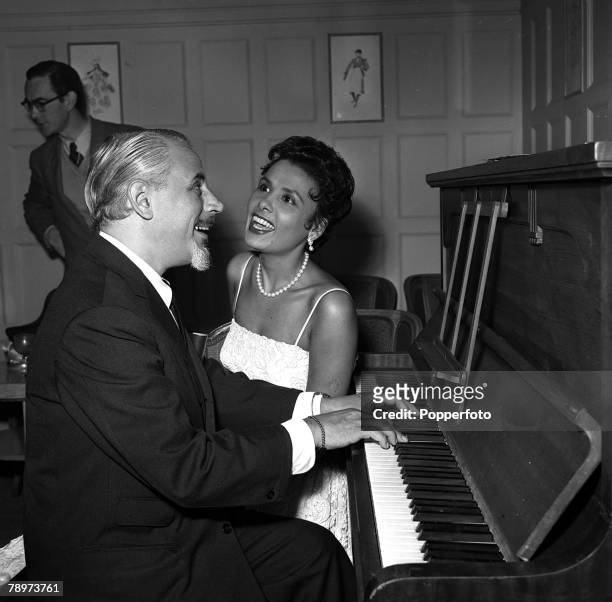 Singer Lena Horne with her husband Lennie Hayton at the piano in London before making her cabaret debut at the Savoy Hotel, 1955.