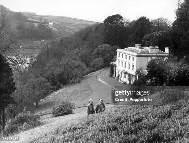 January 1946, British Crime Author Agatha Christie talks with her husband Max Mallowan as they walk outside their Devonshire home, Greenway House