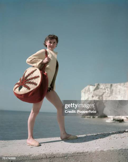 Belgian born British actress and dancer Audrey Hepburn posed with shoulder bag and espadrilles standing on the chalk cliffs by the English Channel...