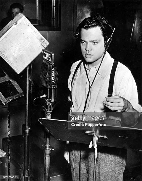 Film director, actor, producer, screenwriter and broadcaster Orson Welles speaking into a CBS microphone during a radio broadcast, 1938.