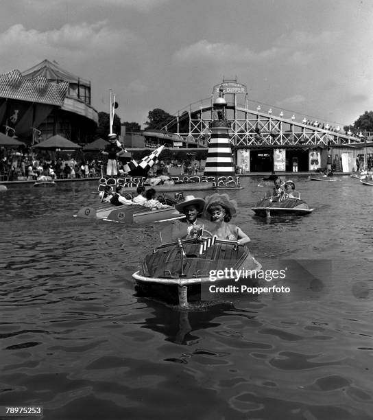 Film stars, John McCallum and Pauline Stroud in a publicity stunt at Batttersea fun-fair, while filming "Lady Godiva rides again"